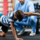 Physical therapist guiding a young boy through exercises for stability and balance